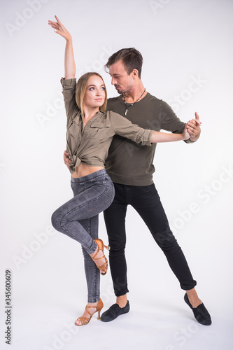 Beauty couple dancing social dance. Kizomba or bachata or semba or taraxia , on white background. Social dance concept. photo