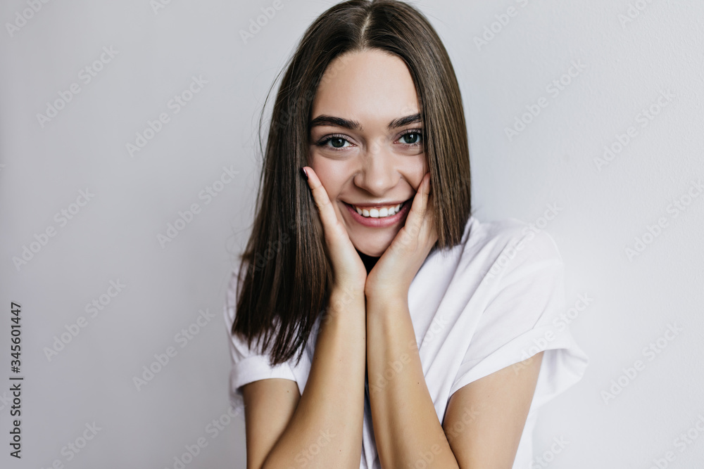 Close-up portrait of magnificent girl with big brown eyes. Indoor shot of romantic lightly-tanned woman posing with sincere smile. Close-up portrait of magnificent girl with big brown eyes. Indoor shot of romantic lightly-tanned woman posing with sincere smile.