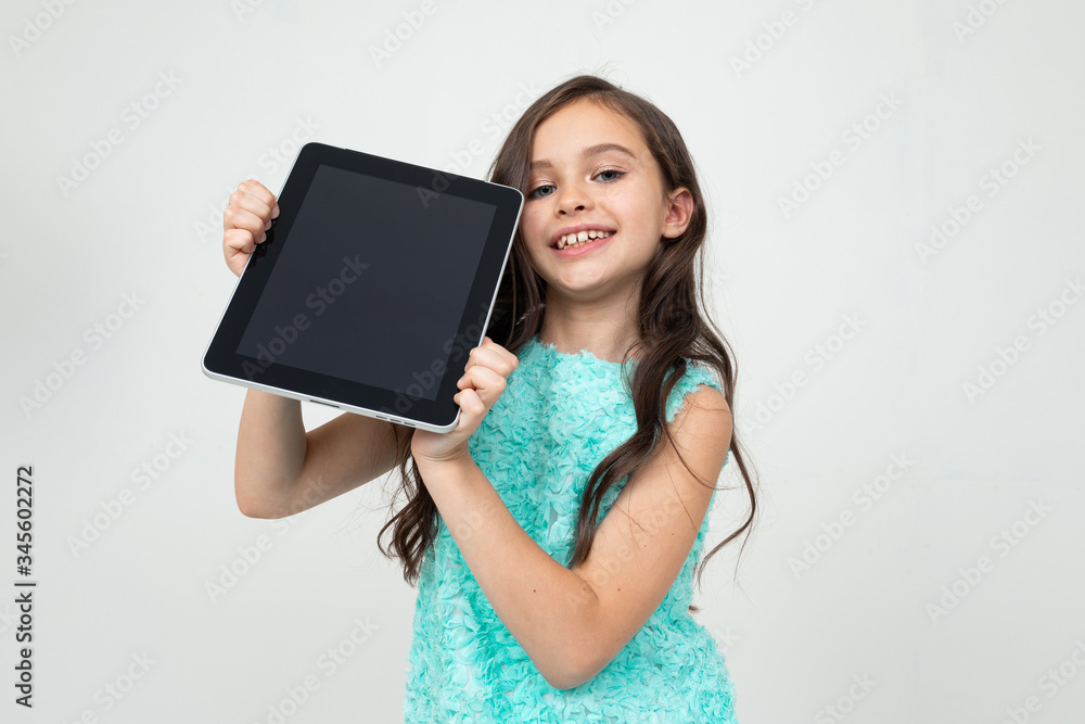 smiling girl holding a tablet with a mockup for inserting a web page or advertisement on a white background with copy space smiling girl holding a tablet with a mockup for inserting a web page or advertisement on a white background with copy space