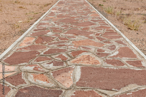 Stone walkway, Akyrtas Palace Complex in Kazakhstan. The path of red stone on the territory of the complex. photo