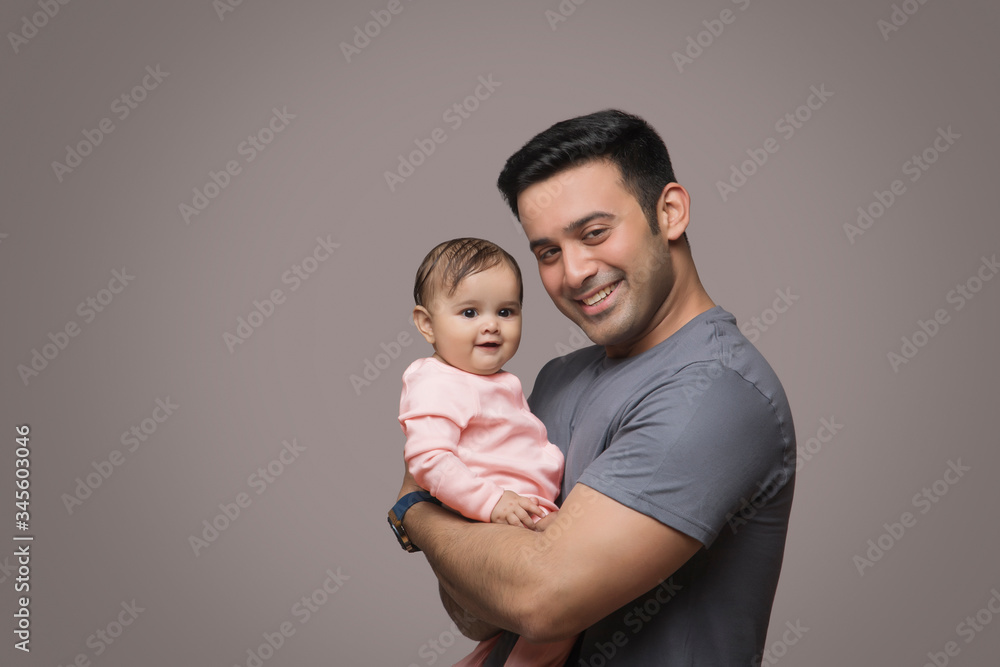 Smiling Father Holding baby girl
