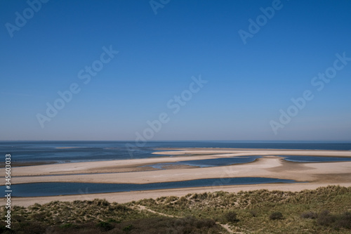 Fototapeta Naklejka Na Ścianę i Meble -  Dutch landscape, North sea sandy beach during low tide near the second Maasvlakte, spring in Netherlands