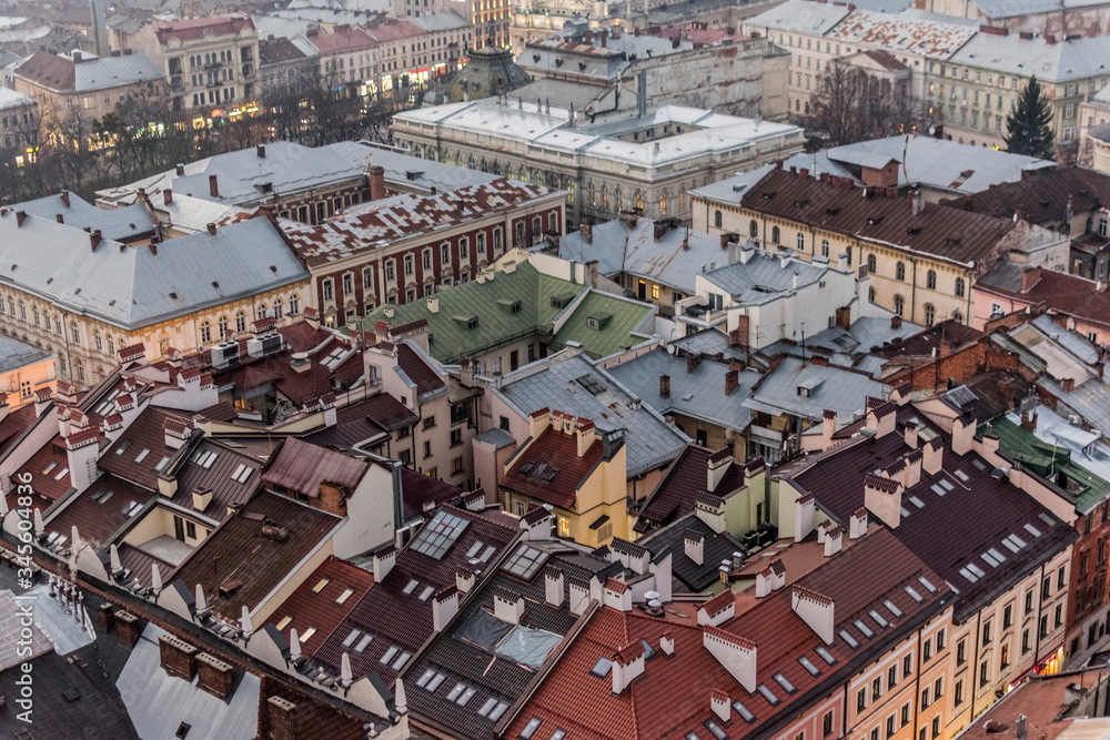 Fototapeta premium Top view from Lviv city hall tower. A lot of buildings roofs, towers, architecture, streets, tenement houses.