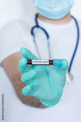 Doctor holding tube with blood for coronavirus test. 2019-nCov epidemic virus concept