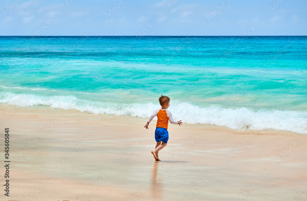 Three year old toddler boy running on beach Three year old toddler boy running on beach