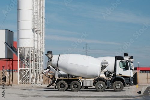 White concrete mixers standing by a modern concrete plant. © Iwona