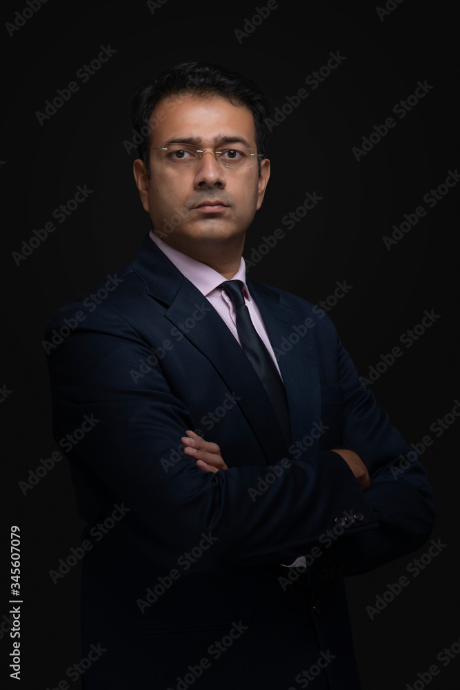 Portrait of a businessman in eyeglasses standing with arms crossed
Portrait of a businessman in eyeglasses standing with arms crossed