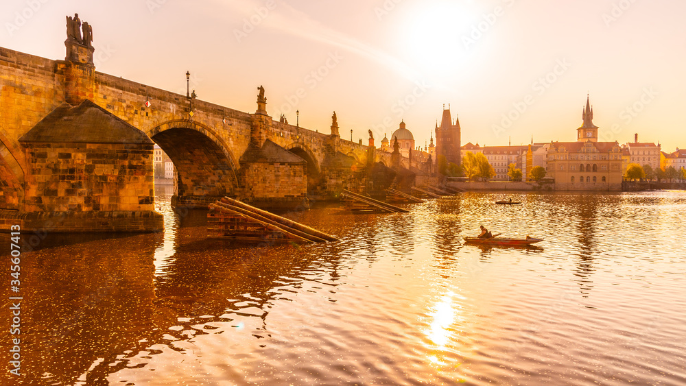 Fototapeta premium Fishing under Charles Bridge, Czech: Karluv most. Sunny morning on Vltava River. Prague, Czech Republic