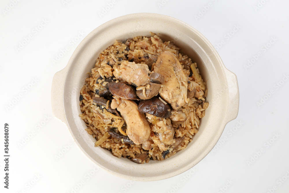 Clay pot chicken rice with mushroom in clay ceramic bowl on white background