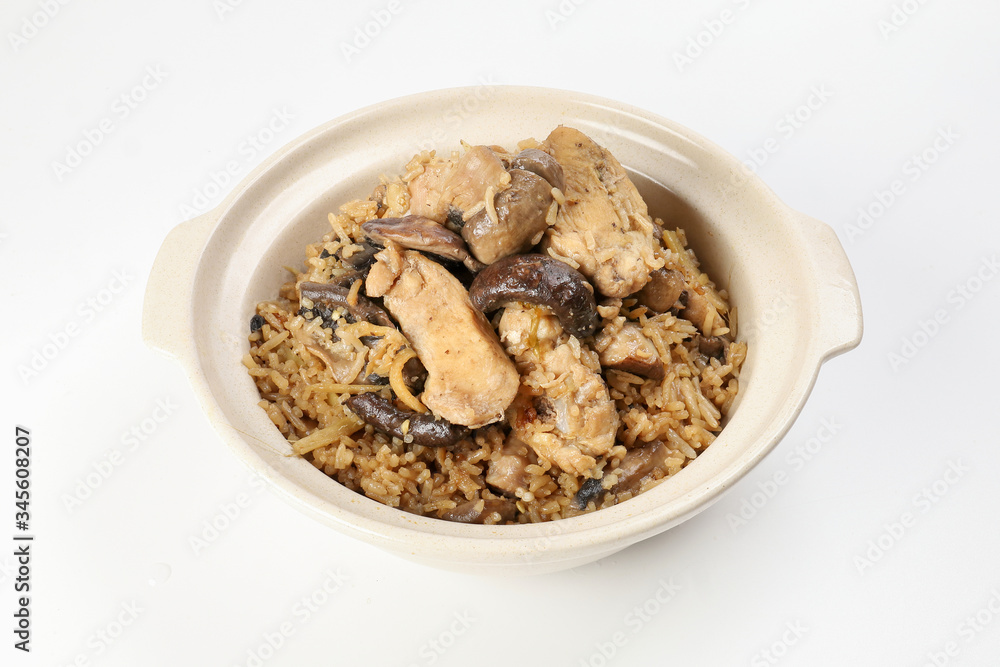 Clay pot chicken rice with mushroom in clay ceramic bowl on white background Clay pot chicken rice with mushroom in clay ceramic bowl on white background