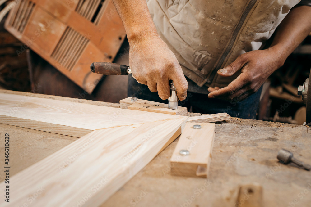 The joiner fix the woodwork in the carpentry The joiner fix the woodwork in the carpentry