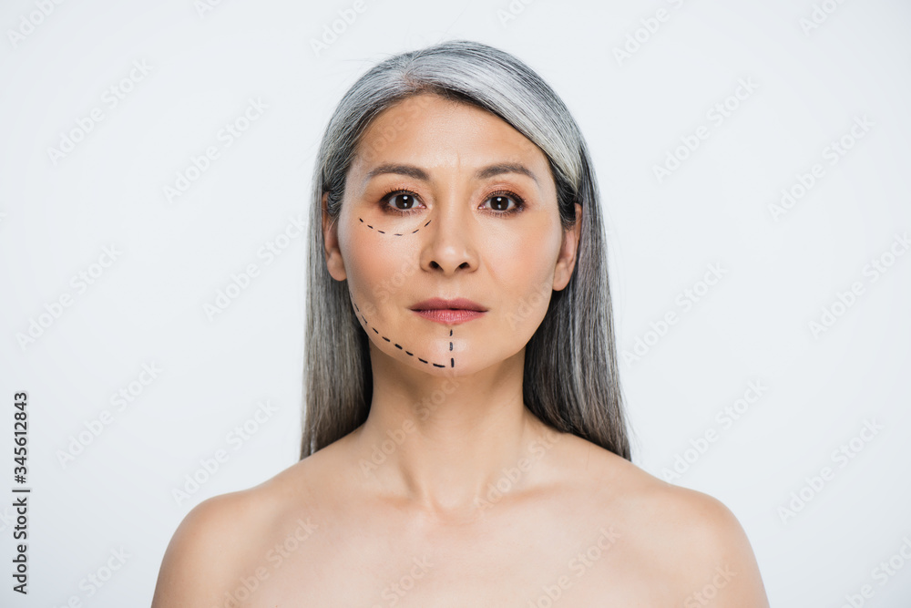 attractive naked asian woman with plastic surgery lines on face isolated on grey attractive naked asian woman with plastic surgery lines on face isolated on grey