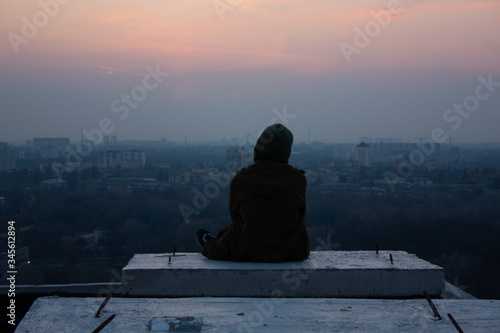man sitting on the edge of the roof view of Kiev