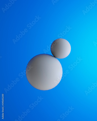 Two white spheres in front of blue background