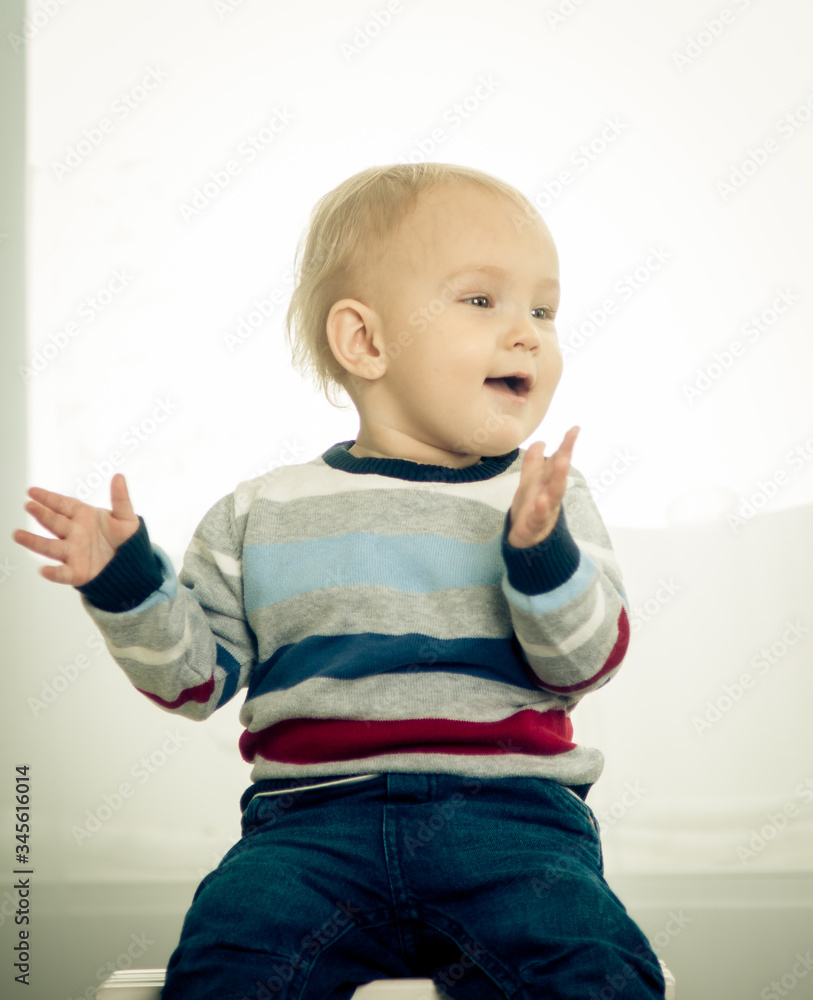 little boy with blond hair playing at home little boy with blond hair playing at home