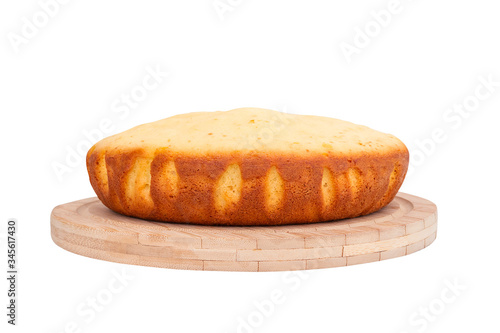 Homemade sponge cake on wooden plate. Close-up. photo