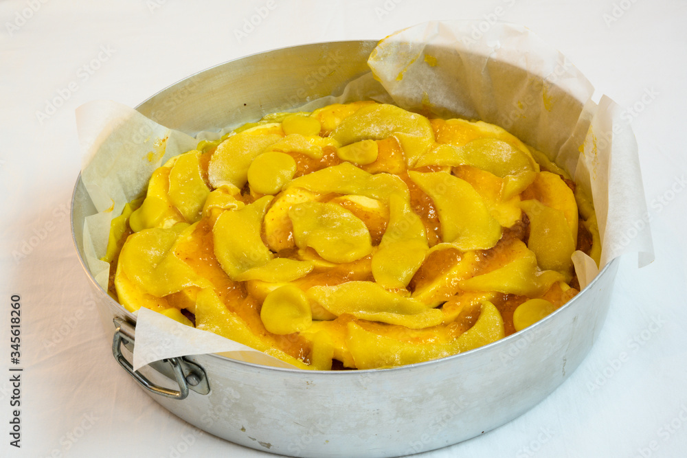Crostata cake made with apple and apricot jam in a round baking pan Crostata cake made with apple and apricot jam in a round baking pan