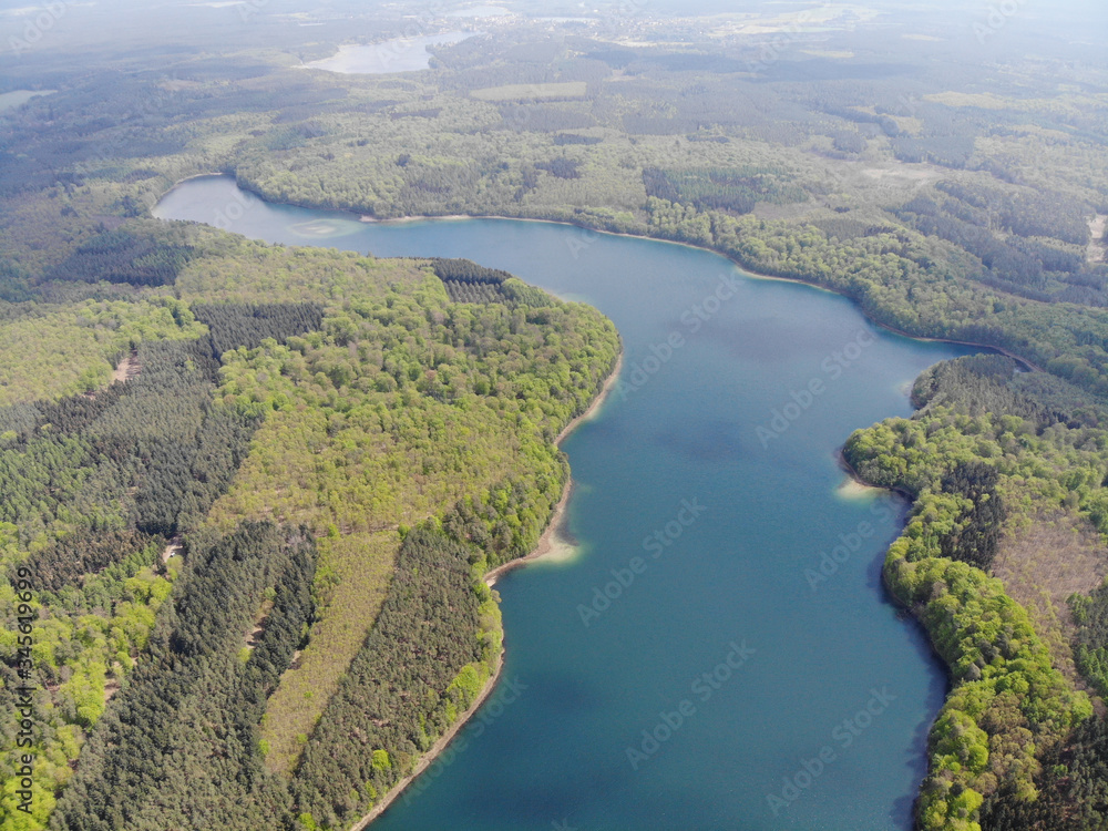 Aerial view of crystal clear Peetschsee located in Stechlin conservation area, Brandenburg Germany