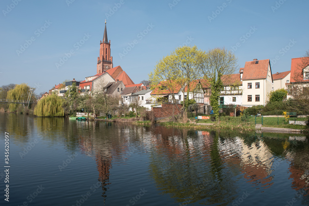 Obraz premium St. Marien-Andreas church at the city canal at the old harbour in Rathenow 