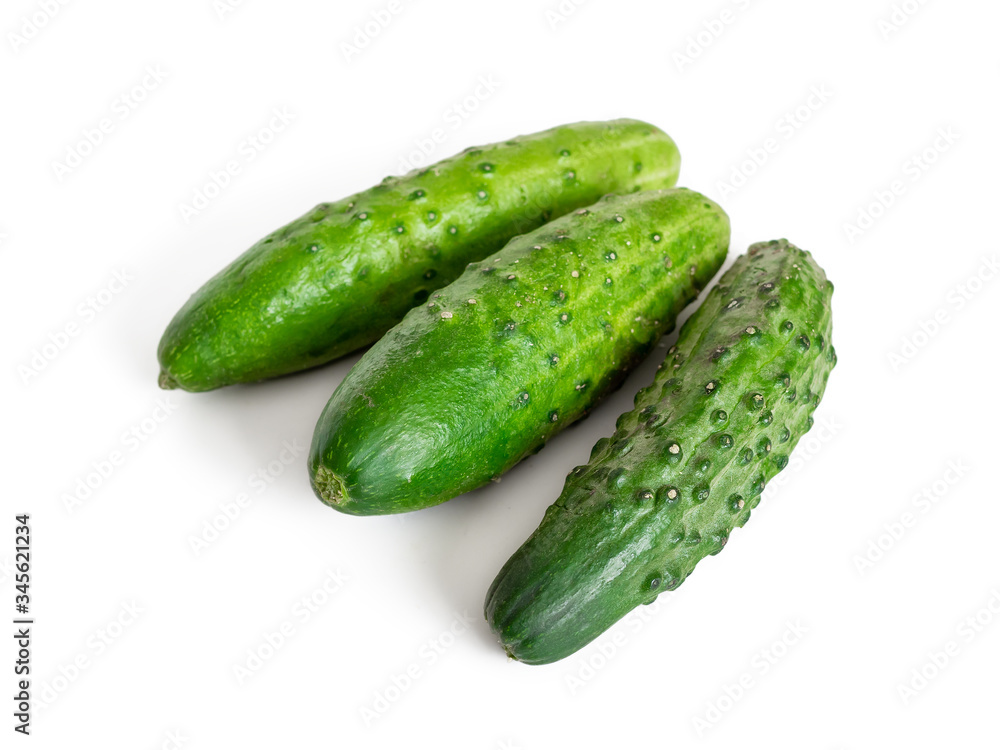 Ripe green cucumbers on a white background for a healthy diet Ripe green cucumbers on a white background for a healthy diet