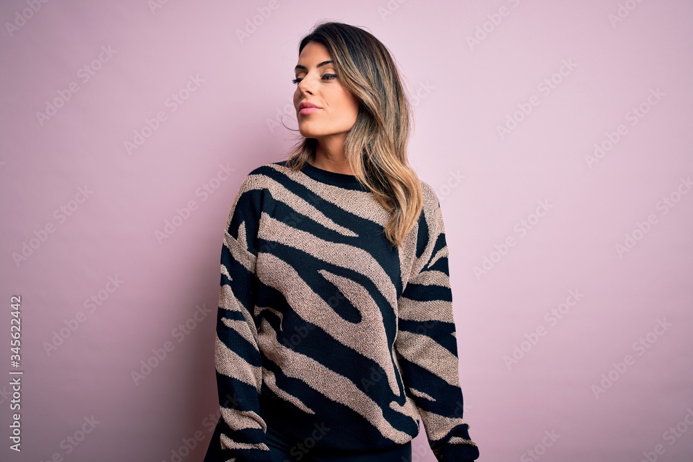 Young beautiful woman wearing fashion urban clothes, model wearing casual street style standing over pink background Young beautiful woman wearing fashion urban clothes, model wearing casual street style standing over pink background