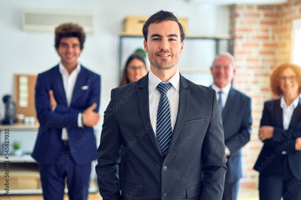 Group of business workers smiling happy and confident in a meeting. Standing with smile on face looking at camera at the office. Group of business workers smiling happy and confident in a meeting. Standing with smile on face looking at camera at the office.