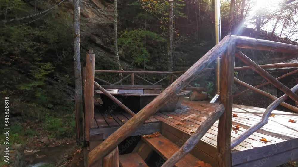 A house for tourists visiting visitors is made of a pile of trees with a hot bath which is made with a platform in the open air. Tourism in the mountains of the Carpathians, Ukraine. Prores 422 A house for tourists visiting visitors is made of a pile of trees with a hot bath which is made with a platform in the open air. Tourism in the mountains of the Carpathians, Ukraine. Prores 422