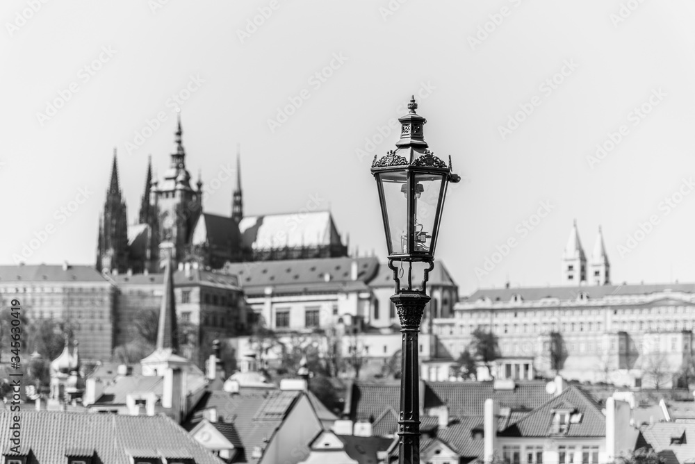 Vintage street lamp on Charles Bridge. Prague Castle out of focus on the background. Prague, Czech Republic