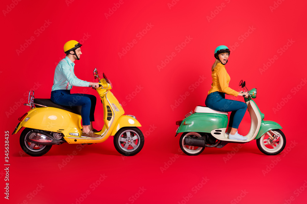 Profile side view of her she his he nice attractive positive cheerful cheery couple driving vehicle traveling having fun time isolated on bright vivid shine vibrant red color background
