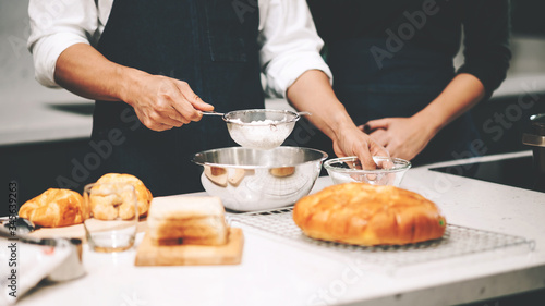 Young Adult Asian Couple Preparing ans Made Homemade Bakery Cooking Together in the Kitchen at Home