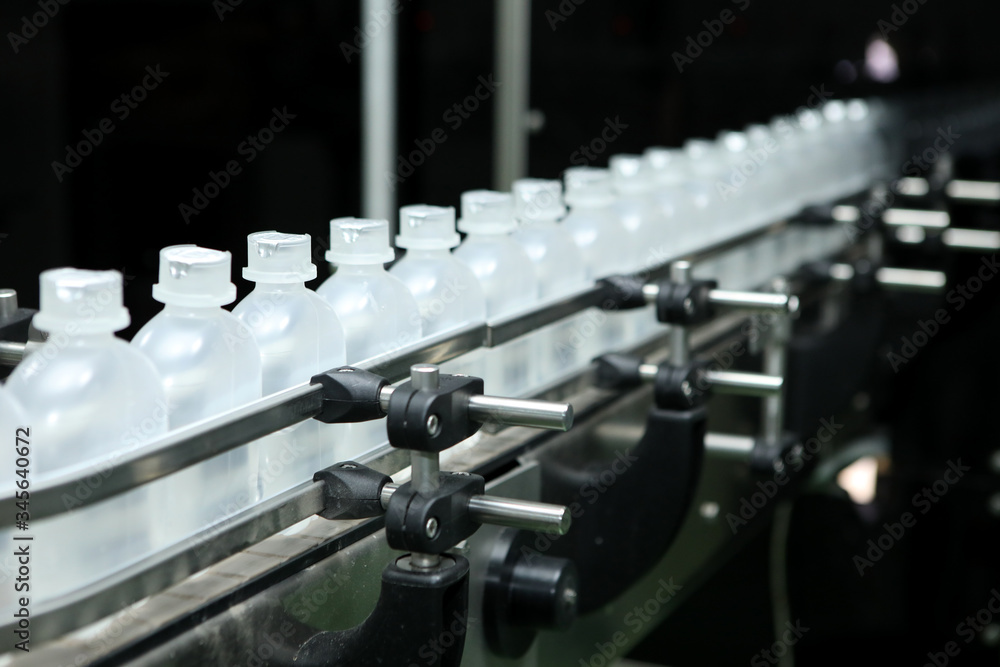 pharmaceutical industry, medicine pills are filling in the plastic bottle on production line machine conveyor at the medical factory. Ampoule filling and sealing machine, equipment in pharmaceutical. pharmaceutical industry, medicine pills are filling in the plastic bottle on production line machine conveyor at the medical factory. Ampoule filling and sealing machine, equipment in pharmaceutical.