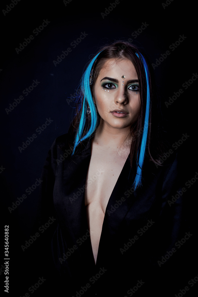 ethnic girl on a black background in blue light ethnic girl on a black background in blue light