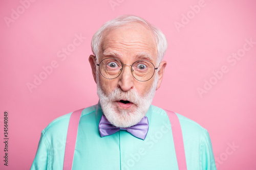 Closeup photo of attractive stylish cool clothes grandpa positive facial expression open mouth wear specs mint shirt suspenders bow tie isolated bright pink pastel color background