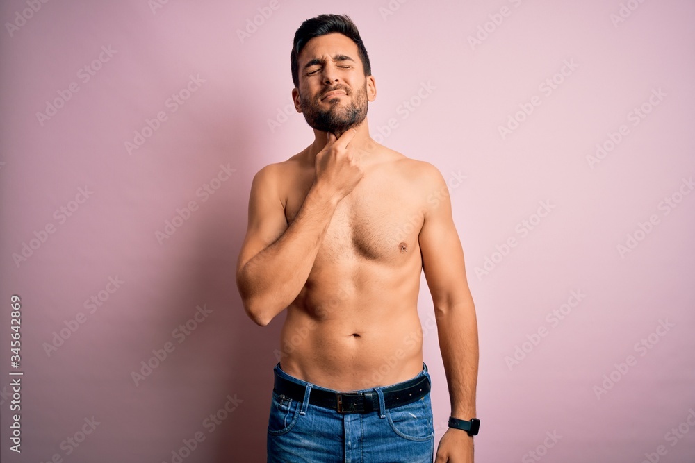 Young handsome strong man with beard shirtless standing over isolated pink background Touching painful neck, sore throat for flu, clod and infection Young handsome strong man with beard shirtless standing over isolated pink background Touching painful neck, sore throat for flu, clod and infection