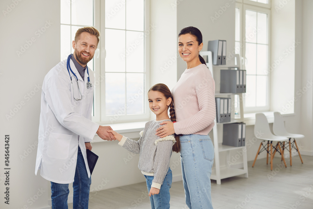 Woman with daughter visiting doctor in hospital