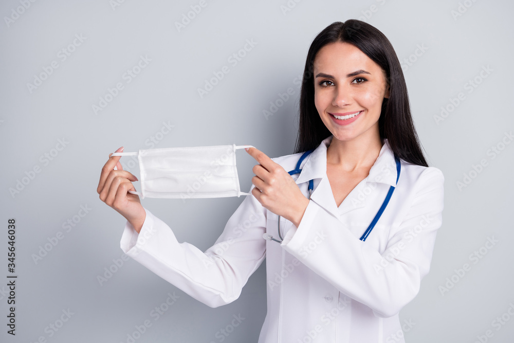 Close-up portrait of her she nice attractive pretty cheerful cheery girl doc holding in hands cotton mask choice advice isolated over grey pastel color background Close-up portrait of her she nice attractive pretty cheerful cheery girl doc holding in hands cotton mask choice advice isolated over grey pastel color background