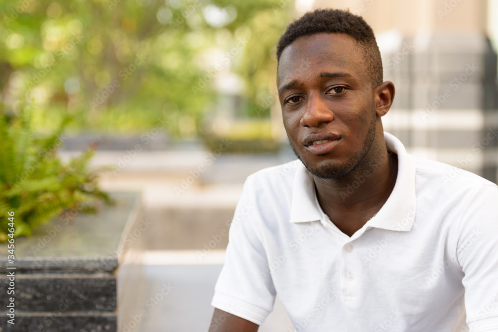 Face of young African man in the city outdoors Face of young African man in the city outdoors