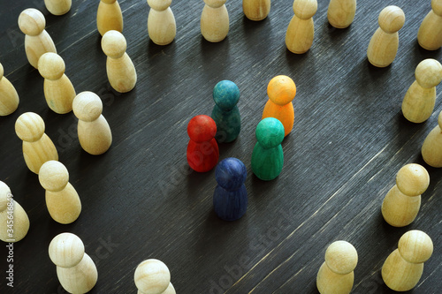 Racism and social exclusion concept. Small group of figures and big one. photo