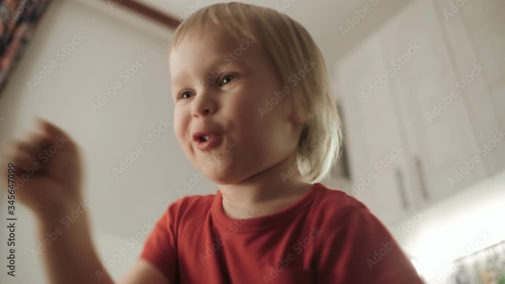 Active child boy fooling dancing and jumping having fun medium close up Active child boy fooling dancing and jumping having fun medium close up