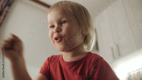 Active child boy fooling dancing and jumping having fun medium close up