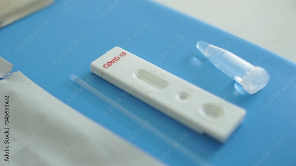 Doctor lays out a kit for the diagnosis of sars-cov-2 coronovirus - test cassette, reagents, scarifier and disinfectant wipe. Express Test Coveid-19 Doctor lays out a kit for the diagnosis of sars-cov-2 coronovirus - test cassette, reagents, scarifier and disinfectant wipe. Express Test Coveid-19