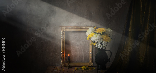 still life with chrysanthemums and golden wooden frame on background old wall
