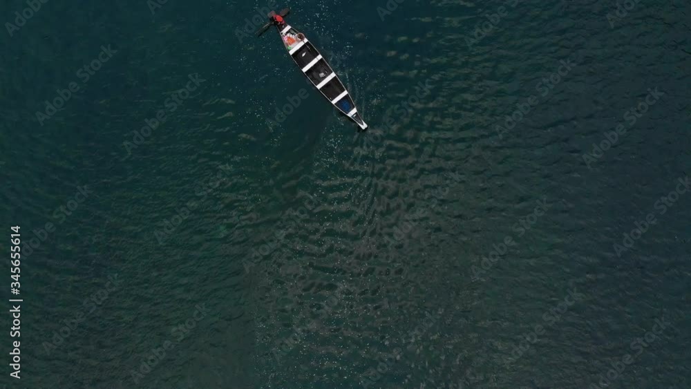 4k Aerial Top Down Shot of a Fisherman paddling with his boat across ...