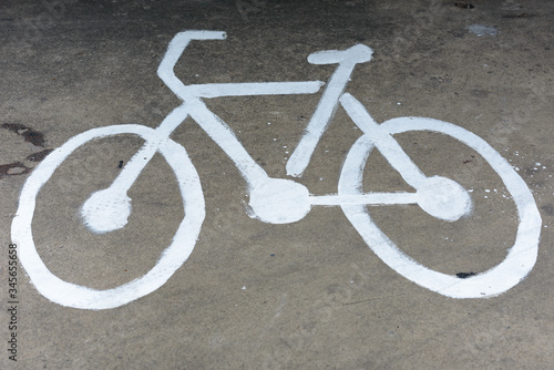 Bicycle sign drawn on the pavement outdoors