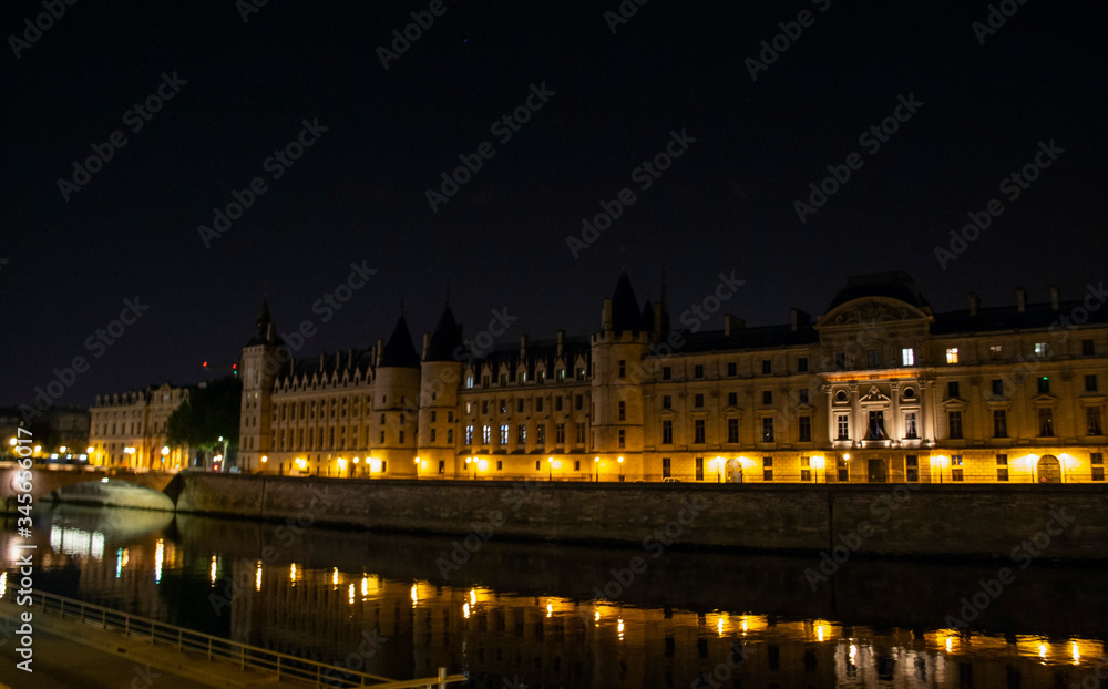 Conciergerie is a former royal castle and prison in the very center of Paris in France at night