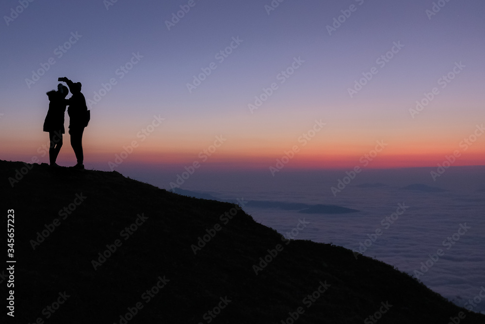 Silhouette of Lovers on twilight  and mist background at the morning in Phu Che Duan,Chieng Rai province,Thailand,January,2020.
