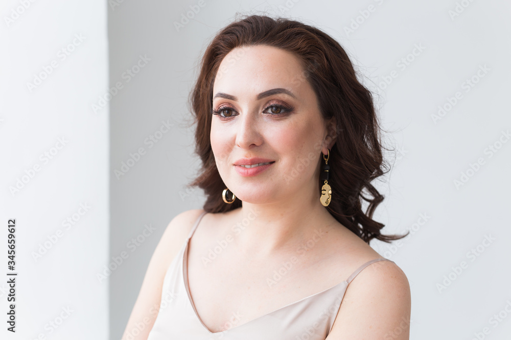 Close-up portrait of beautiful young woman with elegant hairstyle and luxurious jewelry and bijouterie. Close-up portrait of beautiful young woman with elegant hairstyle and luxurious jewelry and bijouterie.