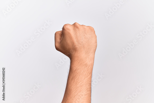 Hand of caucasian young man showing fingers over isolated white background doing protest and revolution gesture, fist expressing force and power