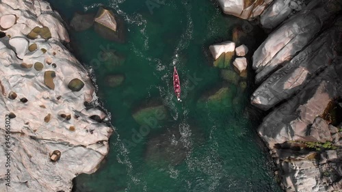 4k Aerial Top Down Shot of a Red Paddle Boat  going on a ride in the Crystal Clear Green Waters of Dawki, Meghalaya photo