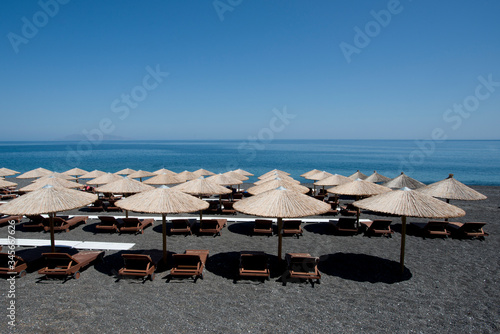 Fototapeta Naklejka Na Ścianę i Meble -  Beach umbrellas and chairs in Greece. Closed season 2020. 